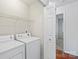 Bright laundry room with shelving, washer, and dryer hookups at 1011 Atherstone Nw St, Conover, NC 28613