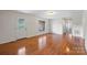 Spacious living room with hardwood flooring, natural light, and neutral paint at 1011 Atherstone Nw St, Conover, NC 28613