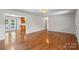 Expansive living room with hardwood floors and seamless transition to kitchen at 1011 Atherstone Nw St, Conover, NC 28613