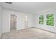 Carpeted bedroom featuring bright, natural light and access to closet storage at 1011 Sandy Ct, Gastonia, NC 28056