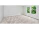 Bright bedroom with neutral carpet, white walls, trim and baseboards, and two large windows at 1011 Sandy Ct, Gastonia, NC 28056