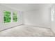 Bright bedroom with large windows and neutral carpet, offering a serene and inviting space at 1011 Sandy Ct, Gastonia, NC 28056