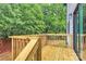 New wooden deck showing fresh lumber, with a view of the trees and natural surroundings at 1011 Sandy Ct, Gastonia, NC 28056