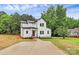 Stunning two-story home with white siding, black accents, landscaped yard, and a spacious driveway at 1011 Sandy Ct, Gastonia, NC 28056