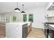 Modern kitchen with stainless steel appliances, island with countertop seating, and bright, natural light at 1011 Sandy Ct, Gastonia, NC 28056