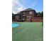 Expansive backyard with a patio, hot tub, and a refreshing pool, perfect for outdoor entertainment at 103 Northchase Dr, Concord, NC 28027