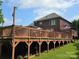 Spacious wooden deck overlooking a well-maintained lawn and featuring an umbrella-covered table at 103 Northchase Dr, Concord, NC 28027