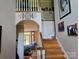 Welcoming foyer with wood staircase, open archway, and decorative 'Welcome' sign at 103 Northchase Dr, Concord, NC 28027
