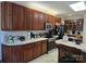 Well-appointed kitchen featuring dark wood cabinets, modern appliances, and a bright, airy atmosphere at 103 Northchase Dr, Concord, NC 28027