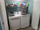 Functional laundry room with modern washer and dryer, storage shelves, and ample space for laundry tasks at 103 Northchase Dr, Concord, NC 28027