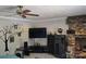 Spacious living room boasts a ceiling fan, entertainment center, and a cozy stone fireplace for ultimate relaxation at 103 Northchase Dr, Concord, NC 28027