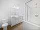 Well-lit bathroom featuring double sinks, a shower with glass doors, and modern fixtures at 10328 Kempsford Dr, Charlotte, NC 28262