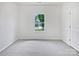 Clean, empty bedroom with carpeted floors, white walls, and a window at 10328 Kempsford Dr, Charlotte, NC 28262