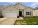 Charming one-story home with a manicured front yard and attached garage at 10328 Kempsford Dr, Charlotte, NC 28262