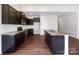 Open kitchen with dark cabinetry, granite countertops, and an island at 10328 Kempsford Dr, Charlotte, NC 28262