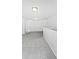 Bright, empty loft with gray carpet, white walls, and a door for flexible space at 10328 Kempsford Dr, Charlotte, NC 28262