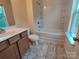 Bathroom with wood vanity, single sink, tub and shower combo, and tile flooring at 11148 Kanturk Ct, Charlotte, NC 28213