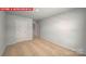 Another view of the neutral bedroom featuring carpeted floors, a closet door, and a window at 11209 Cardinal Creek Ave, Charlotte, NC 28215
