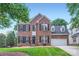 Charming brick home with well-manicured lawn, black shutters, and attached two-car garage at 1220 Elrond Nw Dr, Charlotte, NC 28269