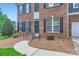 Inviting front entrance with brick steps, iron railing, and well-kept landscaping at 1220 Elrond Nw Dr, Charlotte, NC 28269