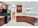 Functional kitchen with dark wood cabinets, bright countertops, and modern appliances at 1220 Elrond Nw Dr, Charlotte, NC 28269