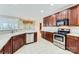 Spacious kitchen features stainless steel appliances, white countertops, and tiled floor at 1220 Elrond Nw Dr, Charlotte, NC 28269