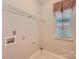 A well lit laundry room featuring tile flooring, and wire shelving at 1220 Elrond Nw Dr, Charlotte, NC 28269