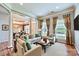 Bright living room with neutral colors, plush seating, and large windows at 1220 Elrond Nw Dr, Charlotte, NC 28269