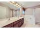 Main bathroom showcasing dual sinks, soaking tub, walk-in shower and lots of light at 1220 Elrond Nw Dr, Charlotte, NC 28269