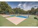 Community pickleball courts with blue and green surfaces, nets, and surrounding trees at 1220 Elrond Nw Dr, Charlotte, NC 28269