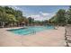 Community pool with a lap lane, sun loungers, pergolas, and a lifeguard stand at 1220 Elrond Nw Dr, Charlotte, NC 28269
