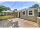 A spacious wooden deck that features new windows, an entranceway, and overlooks the property's charming backyard at 124 Marion St, Clover, SC 29710