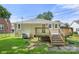 The back of the house has a wooden deck with stairs leading to a well-maintained lawn and cooling AC unit at 124 Marion St, Clover, SC 29710