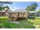 The back of the house with wooden deck and stairs with views to the screened in back porch at 124 Marion St, Clover, SC 29710
