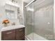 Bathroom featuring modern vanity with storage, glass enclosed shower with decorative tile at 124 Marion St, Clover, SC 29710