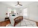 Bright bedroom with patterned curtains, ceiling fan, and plush, decorative rug at 124 Marion St, Clover, SC 29710