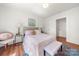 Charming bedroom with neutral walls, wood floors, and a decorative accent bench at 124 Marion St, Clover, SC 29710