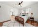 Inviting bedroom featuring wood bed frame, plush rug, lamps, and view to living area at 124 Marion St, Clover, SC 29710