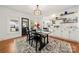 Bright dining room boasts wood floors, white walls, area rug, and stylish light fixture at 124 Marion St, Clover, SC 29710