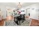 Open dining room with stylish lighting, hardwood floors, seamlessly connected to the kitchen at 124 Marion St, Clover, SC 29710