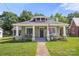 Charming bungalow home featuring a welcoming front porch and well-maintained lawn at 124 Marion St, Clover, SC 29710