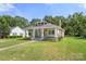Inviting craftsman style home with covered front porch, an American flag, and mature landscaping at 124 Marion St, Clover, SC 29710