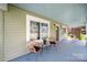 Charming front porch with wicker chairs, perfect for relaxing and enjoying the view at 124 Marion St, Clover, SC 29710