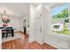 Hallway with hardwood floors leading from dining to entrance, natural light from windows at 124 Marion St, Clover, SC 29710