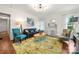 Cozy living room with hardwood floors, coffered ceiling, and stylish, colorful furnishings at 124 Marion St, Clover, SC 29710