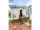View of the back exterior with wood stairs, showing the home's access point and surroundings at 129 Williams Rd, Bessemer City, NC 28016