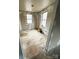 Bedroom ready for renovations showcasing two windows bringing in natural light and potential layout at 129 Williams Rd, Bessemer City, NC 28016