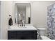 Bathroom featuring a modern vanity, mirror and blue patterned shower curtain at 1315 East Blvd # 203, Charlotte, NC 28203