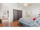 Bright bedroom with a ceiling fan, closet with curtains, and wood floors at 1315 East Blvd # 203, Charlotte, NC 28203