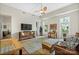 Bright living room with hardwood floors, a ceiling fan, and abundant natural light from large windows at 1315 East Blvd # 203, Charlotte, NC 28203